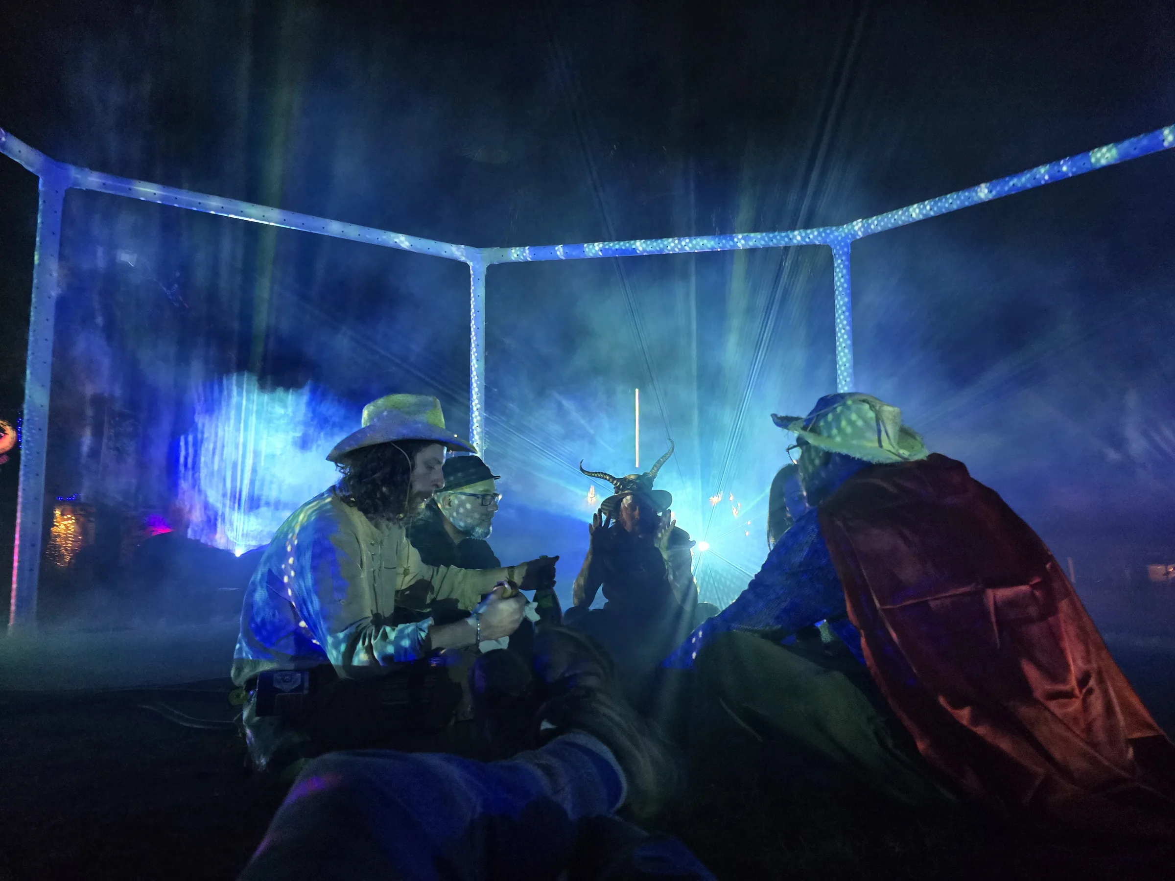 The Octagon: an octagonal truss structure at night filled with fog and eight converging projections